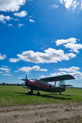 airplane on the green field. blue cloudy sky