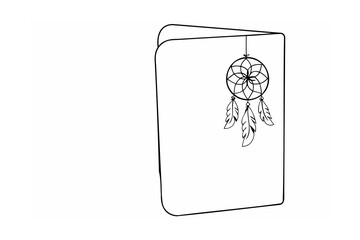 Dreamcatcher with feathers hanging from a notebook