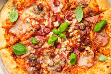 Delicious meat pizza with ham, salami and sausages.