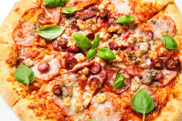 Delicious meat pizza with ham, salami and sausages.