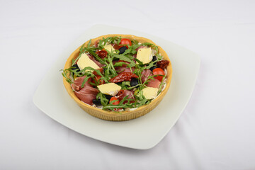 Pie with meat, olives, cheese and arugula