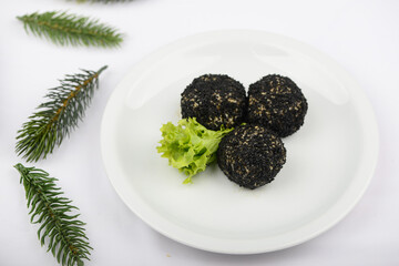 cheese balls in a black fur coat on sticks on a white background with decor