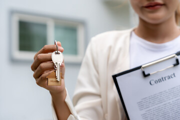 lease, rental and selling home. Real estate agent manager smile holding key for new owner. rent...
