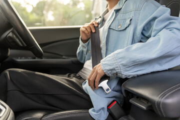Woman use seatbelt and drives with intent, safe driving, driving practice, cheerful woman sits...