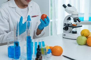 Scientist check chemical food residues in laboratory. Control experts inspect quality of fruit,...