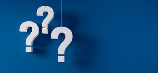 Three hanging white question marks in front of a blue wall with copy space - 3D illustration