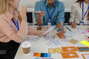 ux, ui, web and mobile app designers are discussing the look and feel of the website or app they...