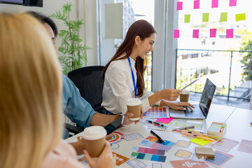 ux, ui, mobile app web designers are brainstorming to design a visual display that customers will...