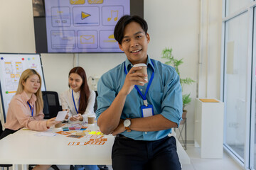 ux, ui, mobile application designer looks at the camera, web designer looks at the camera, working...