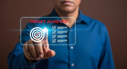 Man in blue shirt touching holographic "TARGET ACHIEVED" screen with target and checkmarks, symbolizing success.