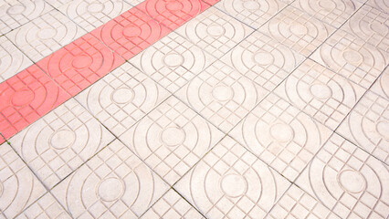Concrete pavement floor background with red and white modern geometric abstract pattern, high angle view with copy space 