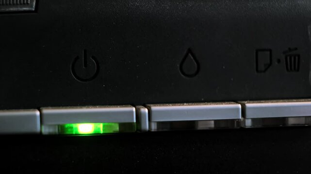 The green light on the printer is on and the red light is flashing, indicating a malfunction of the device or the need to refill it with ink. The need for office equipment maintenance. 4k footage.