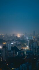 Night cityscape shows urban scene with high-rise buildings and illuminated city lights