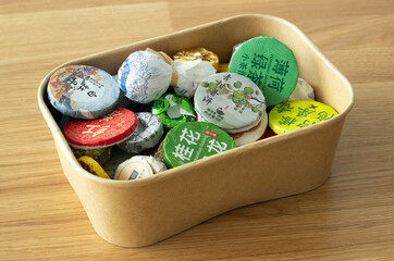 a box of different types of traditional chinese tea used for tea ceremony, isolated on wooden table
