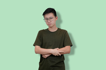 Young Man confident pose Against Solid Pastel Green Background