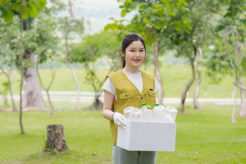 Young Woman Carrying Recyclables in Park