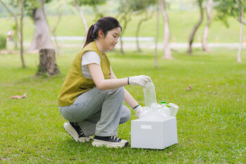 Woman Collecting Plastic Bottles in Park