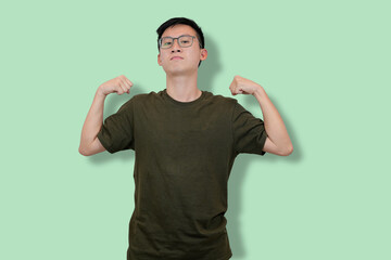 Confident Young Man Showing Strength on a Minimalist Background