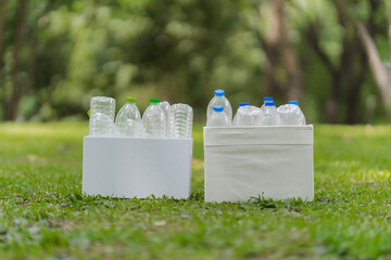 Recycled Plastic Bottles in Boxes on Green Grass