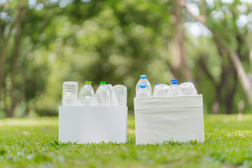 Plastic Bottles in Boxes for Recycling on Green Grass