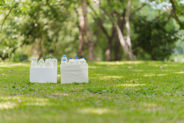 Plastic Bottles in Boxes on Green Lawn