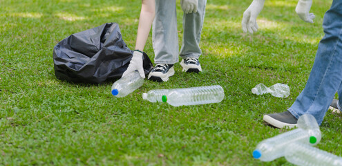 People Collecting Plastic Bottles in Park