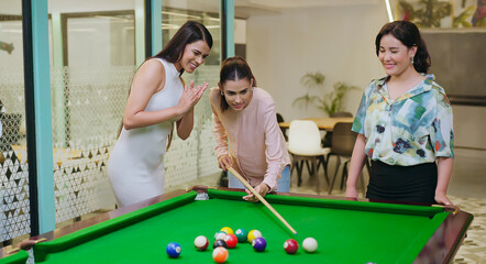 Indian happy young adult gen z woman lady hold cue stick hit ball play sport game on pool table...