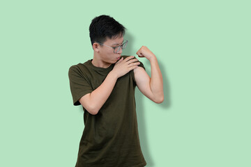 Confident Young Man Showing Strength on a Minimalist Background