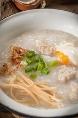 Close-up of rice porridge or pork congee for breakfast, boiled eggs, fried dough sticks, soft-boiled eggs.