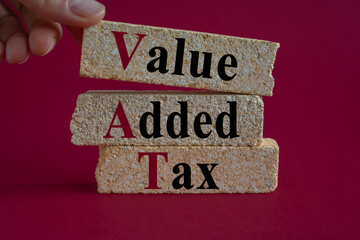 VAT - Value Added Tax symbol. Concept words Value Added Tax on brick blocks. Beautiful red...