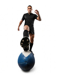 Rugby player in black kit viewed from an uncommon perspective with a large rugby ball dominating the foreground for impressive effect.