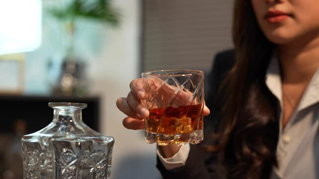 Closeup business woman holding a glass of whiskey