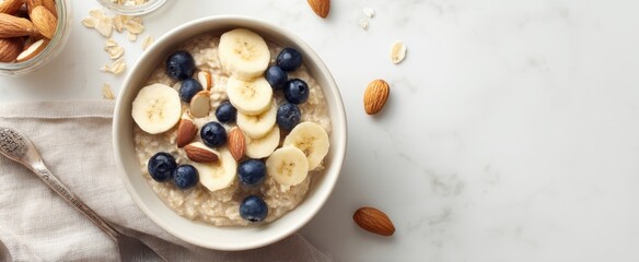 The delicious oatmeal bowl topped with bananas, blueberries, and almonds.