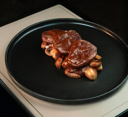 Beef Tenderloin Medallions with Baby Potatoes and Mushrooms in Rich Demi-Glace Sauce. Ideal for restaurant menus, gourmet food blogs, and fine dining promotions.