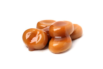 Tasty sweet candies and caramel sauce isolated on white