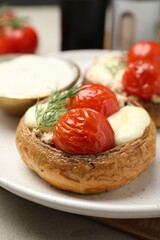 Tasty stuffed mushrooms served on table, closeup