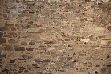 Stone antique old wall as a background or texture. Vintage background of a fortress wall in loft...