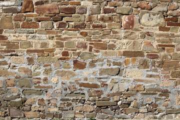 Stone antique old wall as a background or texture. Vintage background of a fortress wall in loft...
