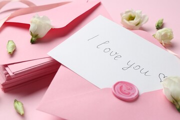 Stack of letters, card with phrase I Love You and flowers on pink background, closeup