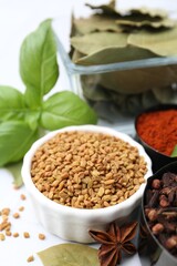 Different aromatic spices on white table, closeup