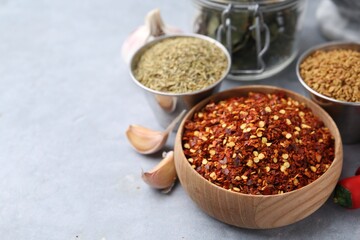 Different aromatic spices on grey table, closeup. Space for text