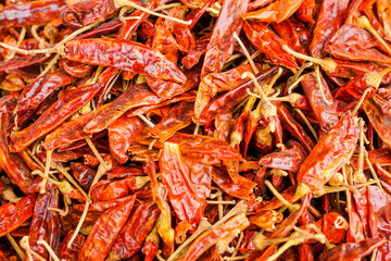 Close-up of preserved red chilies, showcasing intense color, texture, and natural sheen. Ideal for illustrating heat, flavor, and traditional Southeast Asian cooking ingredients.