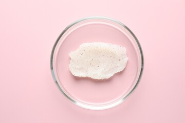 Cosmetic product in Petri dish on pink background, top view