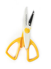 Zigzag wavy pattern scissors on a white background. Yellow creative scissors with serrated blades for decorative cutting. Scissors for crafts, card making, scrapbooking and other DIY projects.