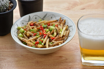  Pupae in bamboo fried crispy insect protein food, appetizer or snack local Thai food, Bamboo Caterpillar is food in street food at northern of thailand.