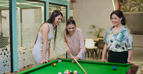 Indian happy young adult gen z woman lady hold cue stick hit ball play sport game on pool table...