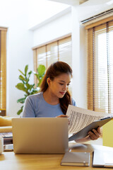 Woman enjoys book and music in modern abode.