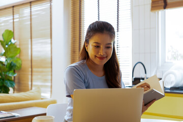 Woman enjoys book and music in modern abode.