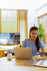 Woman enjoys book and music in modern abode.