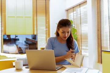 Woman enjoys book and music in modern abode.